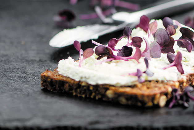 Ein Brot mit Frischkäse bestrichen